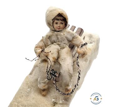Spun cotton girl on sled, ca. 1900