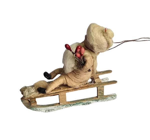 Spun cotton girl on sled, ca. 1900